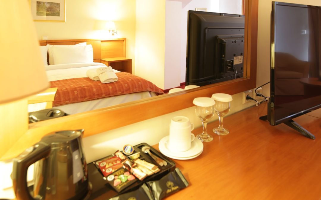 Elegant bedside table detail with warm ambient lamp lighting in luxury Livadia hotel room