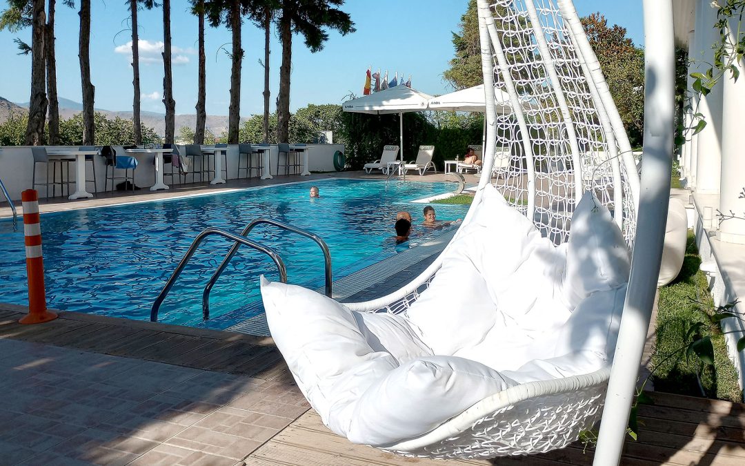 Outdoor swimming pool at Hotel Philippos Livadia surrounded by peaceful summer setting Outdoor swimming pool at Hotel Philippos Livadia surrounded by peaceful summer setting