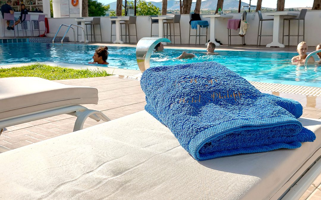 Outdoor swimming pool at Hotel Philippos Livadia surrounded by peaceful summer setting Outdoor swimming pool at Hotel Philippos Livadia surrounded by peaceful summer setting