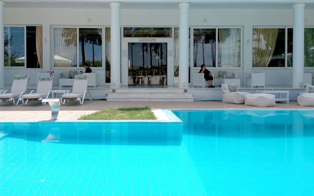 Outdoor swimming pool at Hotel Philippos Livadia surrounded by peaceful summer setting Outdoor swimming pool at Hotel Philippos Livadia surrounded by peaceful summer setting